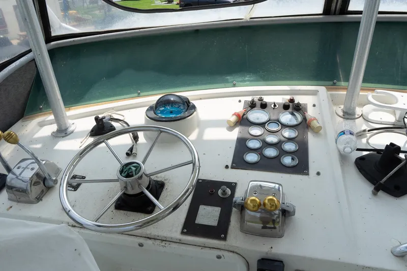 Slide: The Image of 1978 Bertram 35 Flybridge Sportfish helm with steering wheel and instrument panel. - 39