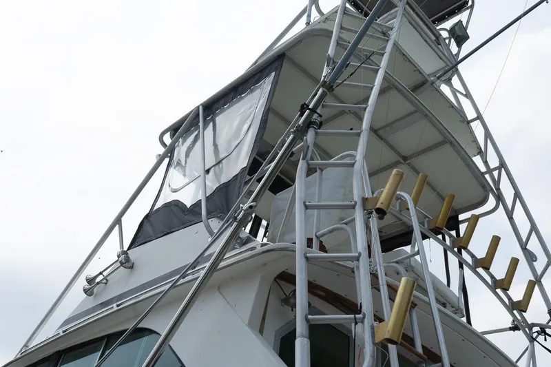 Slide: The Image of 1978 Bertram 35 Flybridge Sportfish boat tower with ladder and rod holders. - 4