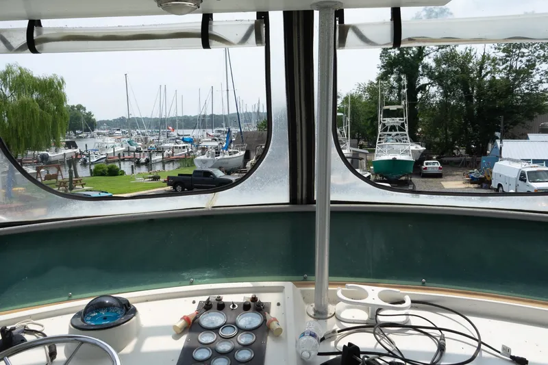 Slide: The Image of View from 1978 Bertram 35 Flybridge Sportfish, overlooking marina with boats and greenery. - 40