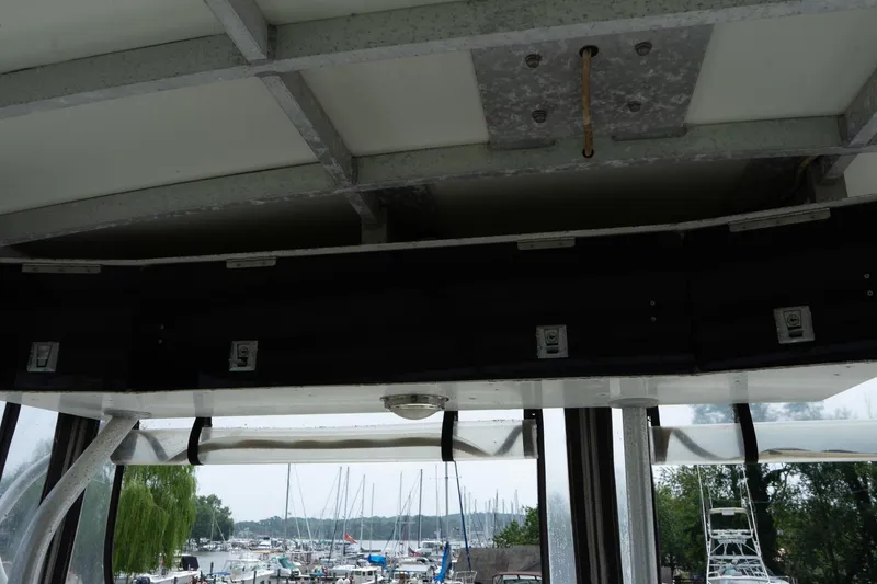 Slide: The Image of Interior view of a 1978 Bertram 35 Flybridge Sportfish boat with marina background. - 41