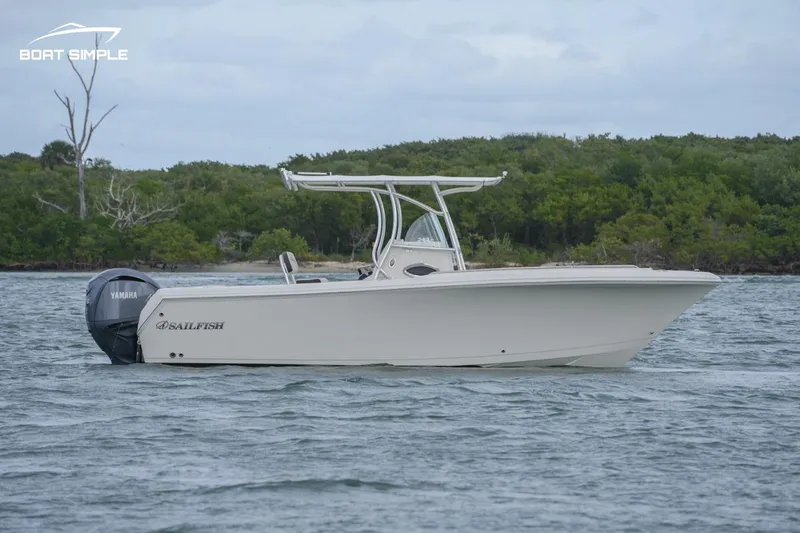 Slide: The Image of 2024 Sailfish 242 CC boat on water, side view, with lush green background. - 1