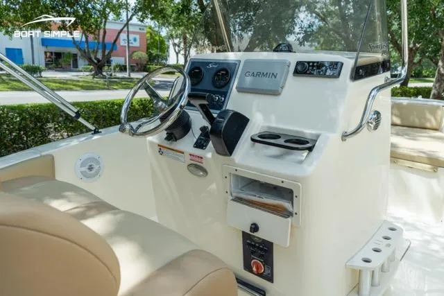 Slide: The Image of 2024 Scout 195 Sportfish boat console with Garmin navigation system and steering wheel. - 7