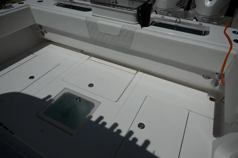 Slide: The Image of 2023 Contender 44 ST boat deck with storage compartments and outboard engines. - 14