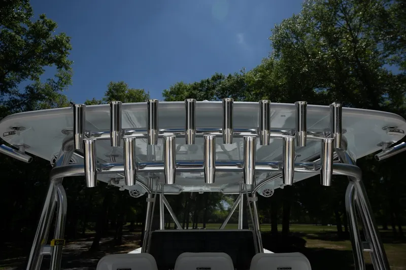 Slide: The Image of 2023 Contender 44 ST boat with stainless steel rod holders under a clear blue sky. - 15