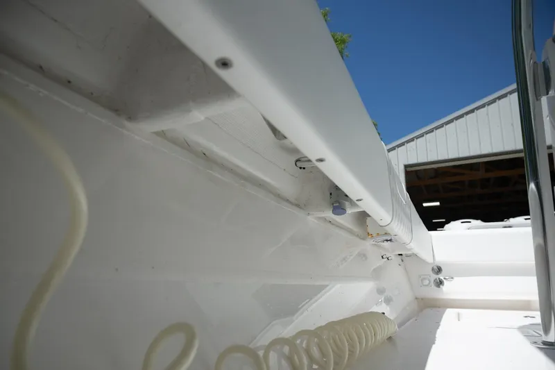 Slide: The Image of 2023 Contender 44 ST boat interior detail with coiled hose and storage compartment. - 20