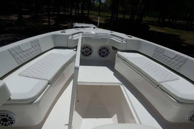 Slide: The Image of 2023 Contender 44 ST boat interior with white cushioned seating and speakers. - 4
