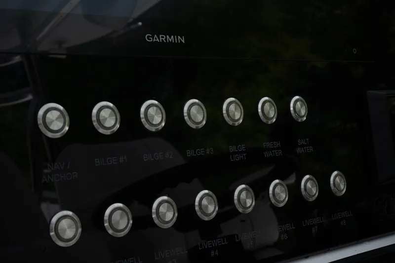 Slide: The Image of Control panel of 2023 Contender 44 ST boat with labeled buttons and Garmin display. - 9