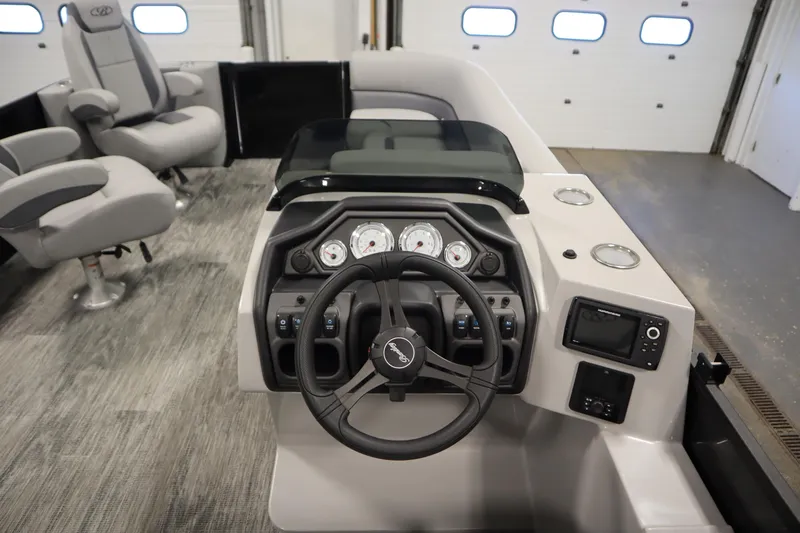 Slide: The Image of 2025 Bentley Pontoons Legacy 243 DL Navigator Tri-toon helm with modern controls and seating. - 16
