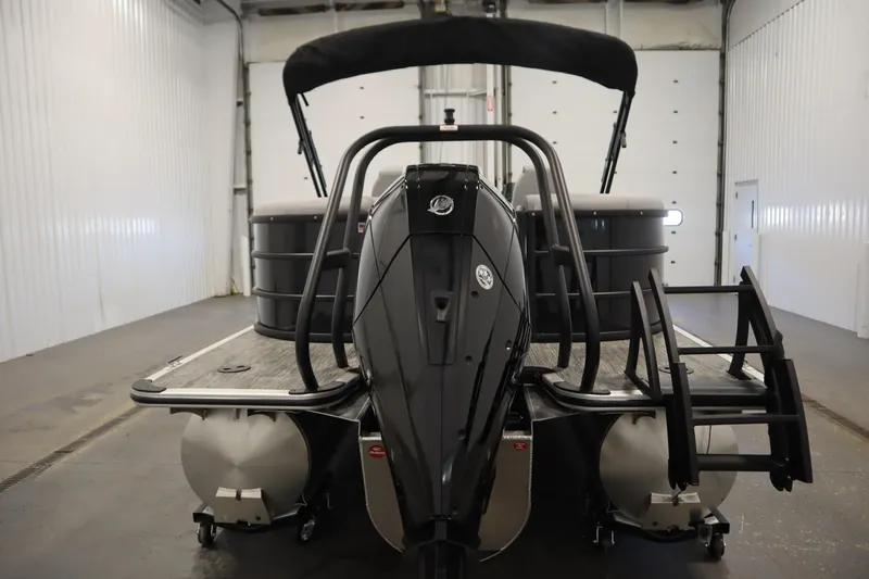 Slide: The Image of 2025 Bentley Pontoons Legacy 243 DL Navigator Tri-toon in a garage, rear view. - 5