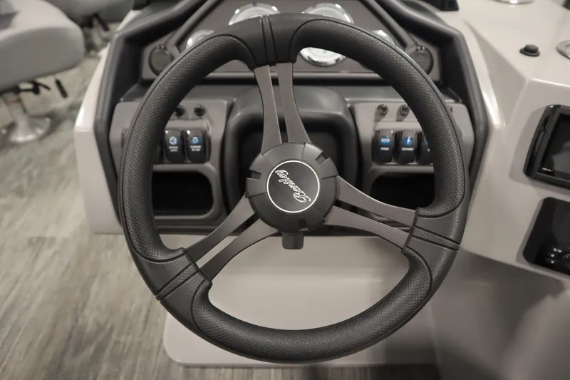 Slide: The Image of 2025 Bentley Pontoons Legacy 243 DL Navigator Tri-toon interior with captain's chair and console. - 17