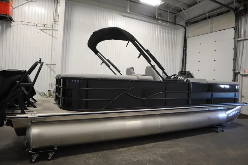 Slide: The Image of 2025 Bentley Pontoons Legacy 243 DL Navigator Tri-toon in a showroom setting. - 3