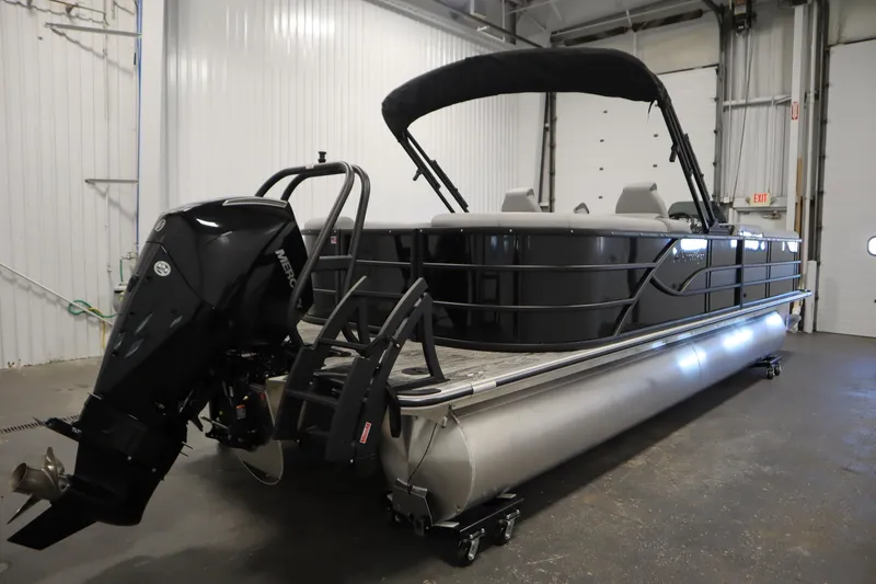 Slide: The Image of 2025 Bentley Pontoons Legacy 243 DL Navigator Tri-toon in a garage, rear view. - 4