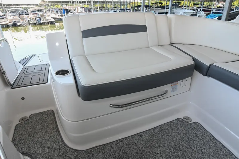 Slide: The Image of 2014 Chaparral 224 Sunesta boat interior with cushioned seating and cup holder. - 18