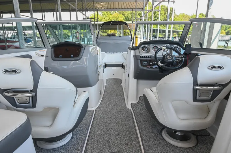 Slide: The Image of 2014 Chaparral 224 Sunesta boat interior with steering wheel and seating. - 22