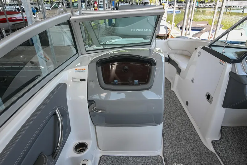 Slide: The Image of 2014 Chaparral 224 Sunesta boat interior with seating and storage compartments. - 24