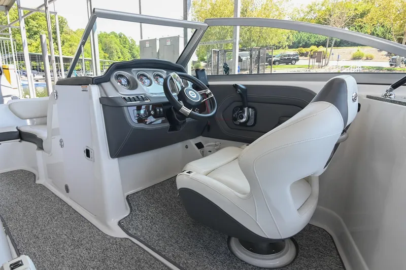 Slide: The Image of 2014 Chaparral 224 Sunesta boat interior with steering wheel and captain's seat. - 28