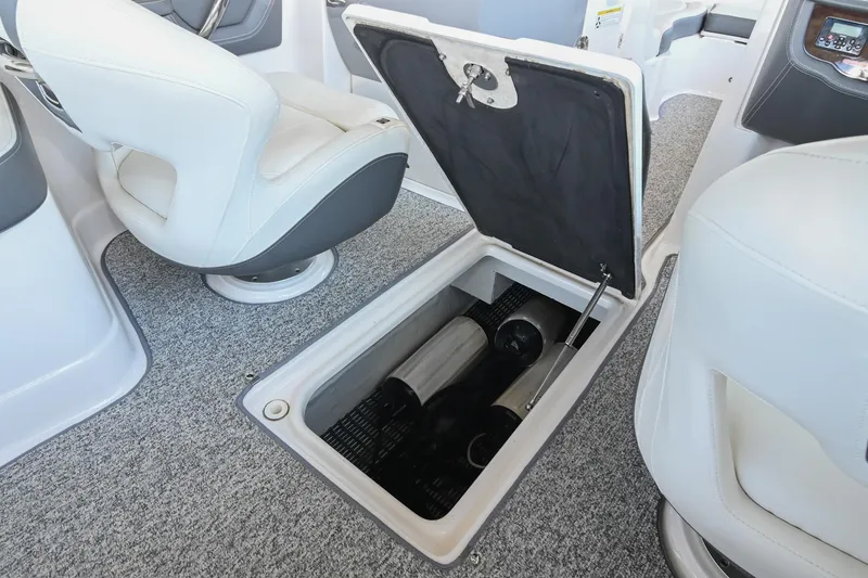 Slide: The Image of 2014 Chaparral 224 Sunesta boat interior with open storage compartment. - 34