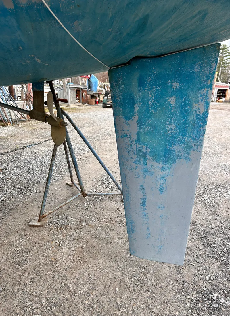Slide: The Image of 1985 Pearson P-28 sailboat keel on dry dock, showing weathered blue paint. - 11