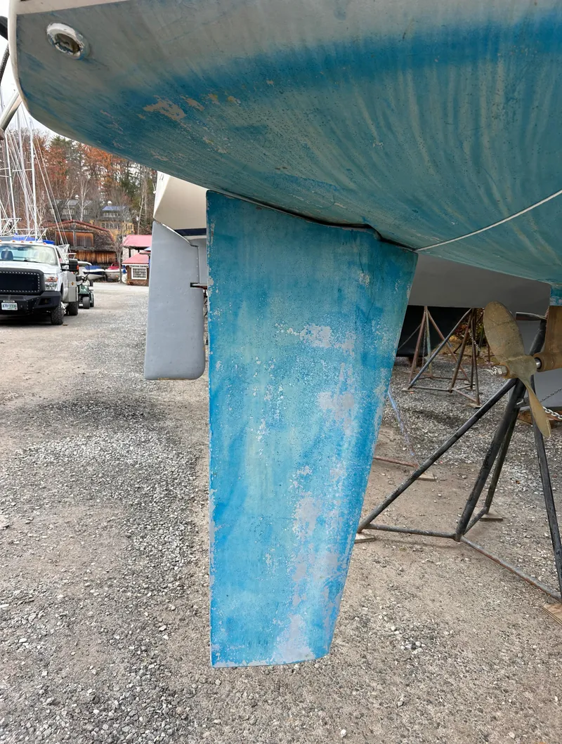 Slide: The Image of 1985 Pearson P-28 sailboat keel on dry dock, showing blue paint and wear. - 12