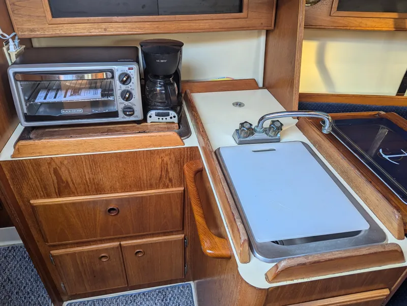 Slide: The Image of 1985 Pearson P-28 yacht kitchen with toaster oven, coffee maker, and sink. - 15