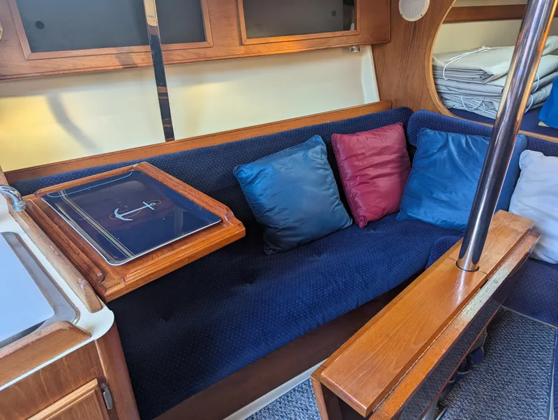 Slide: The Image of Interior of 1985 Pearson P-28 sailboat with cozy seating and colorful cushions. - 16