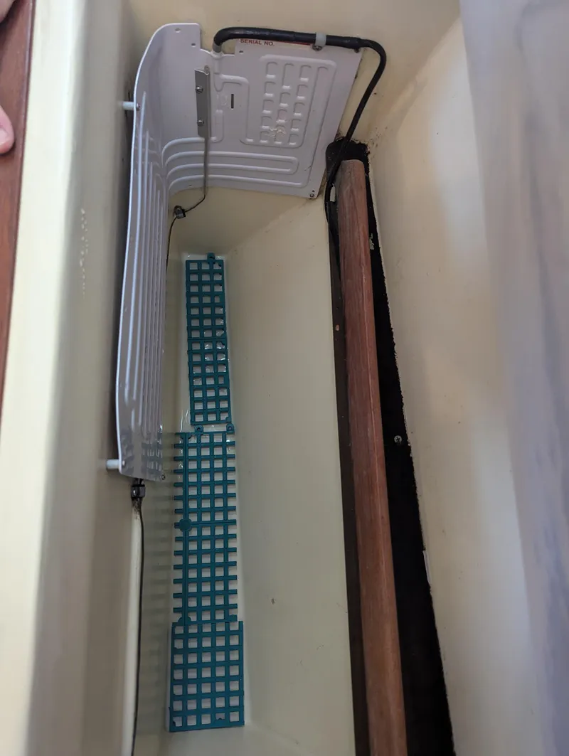 Slide: The Image of Interior view of a 1985 Pearson P-28 sailboat, featuring electrical wiring and components. - 23