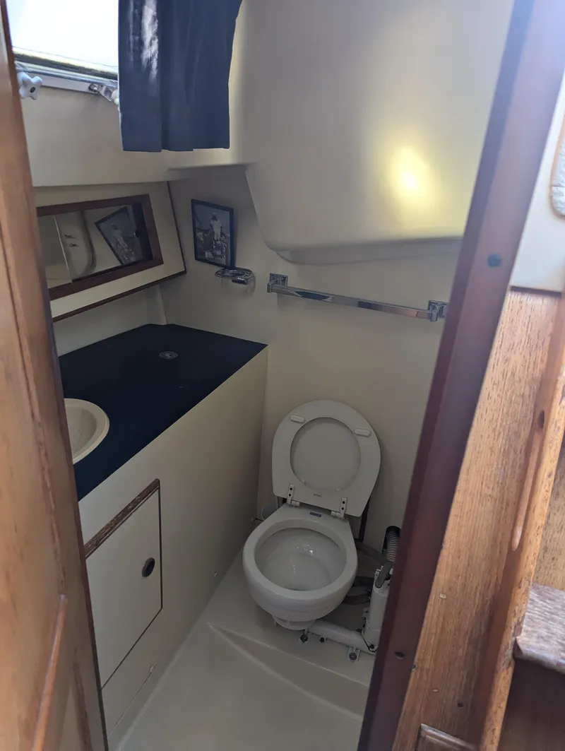 Slide: The Image of 1985 Pearson P-28 sailboat bathroom with toilet and sink. - 25