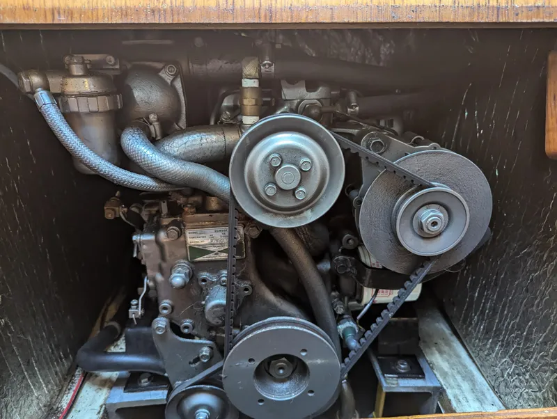 Slide: The Image of 1985 Pearson P-28 engine compartment with visible belts and hoses. - 27