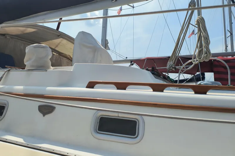 Slide: The Image of 1985 Pearson P-28 sailboat deck with covered equipment and rigging. - 32