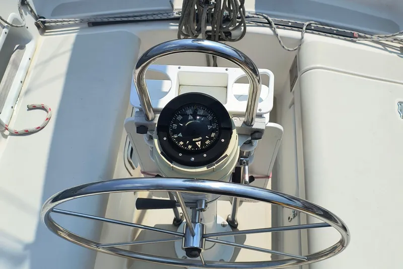 Slide: The Image of Steering wheel and compass on 1985 Pearson P-28 sailboat. - 34