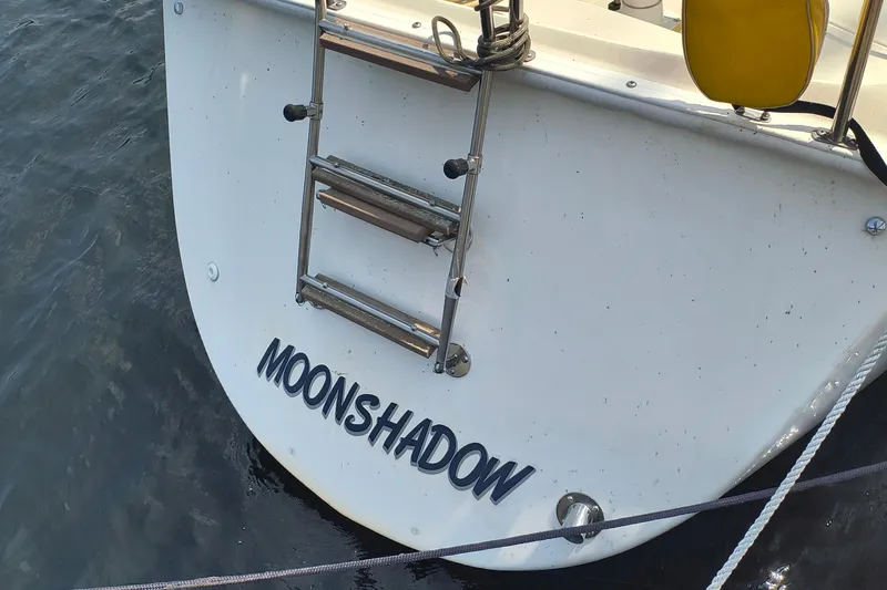 Slide: The Image of Pearson P-28 sailboat "Moonshadow" stern with ladder, 1985 model, on water. - 39