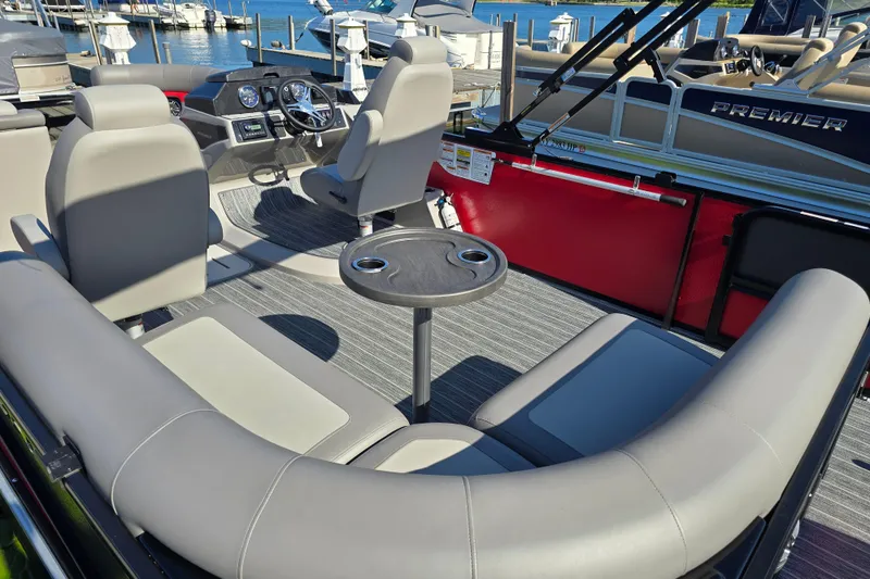Slide: The Image of 2025 Premier 210 SunSation RE pontoon boat interior with seating and steering console. - 13