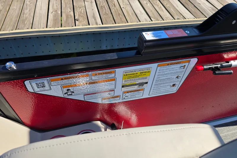 Slide: The Image of 2025 Premier 210 SunSation RE boat with safety and capacity labels on red panel. - 20