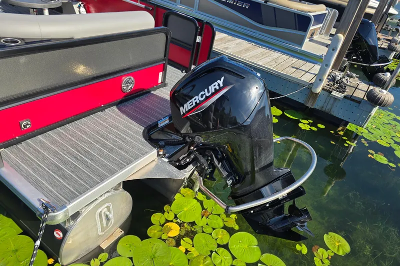 Slide: The Image of 2025 Premier 210 SunSation RE pontoon boat with Mercury outboard motor at dock. - 6