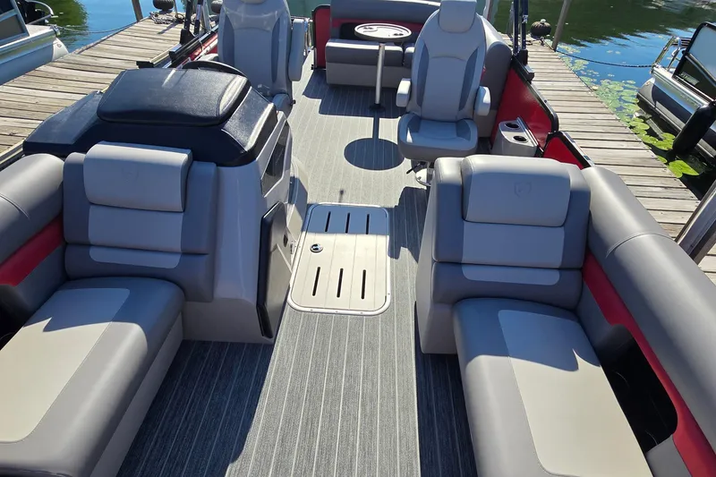 Slide: The Image of Luxurious interior of 2025 Premier 210 SunSation RE pontoon boat at dock. - 7