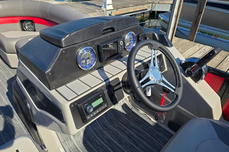Slide: The Image of 2025 Premier 210 SunSation RE boat dashboard with steering wheel and controls. - 8