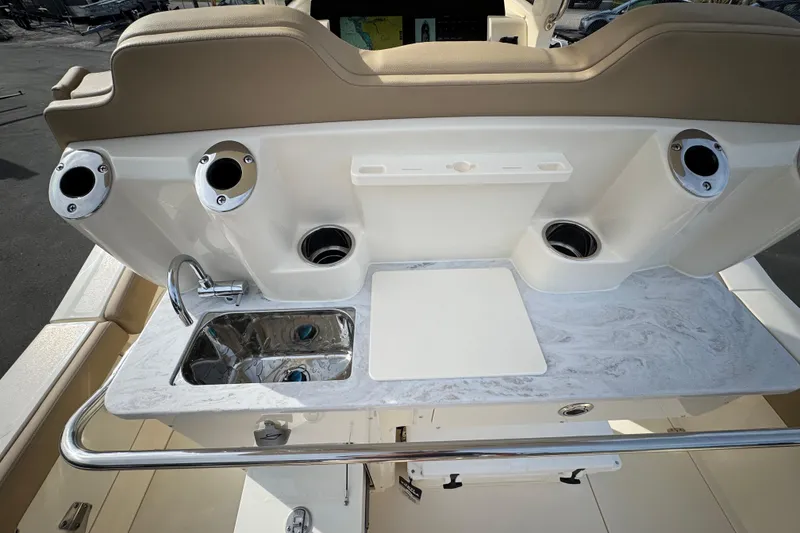Slide: The Image of 2026 Scout 260 LXF boat interior with sink and rod holders. - 10