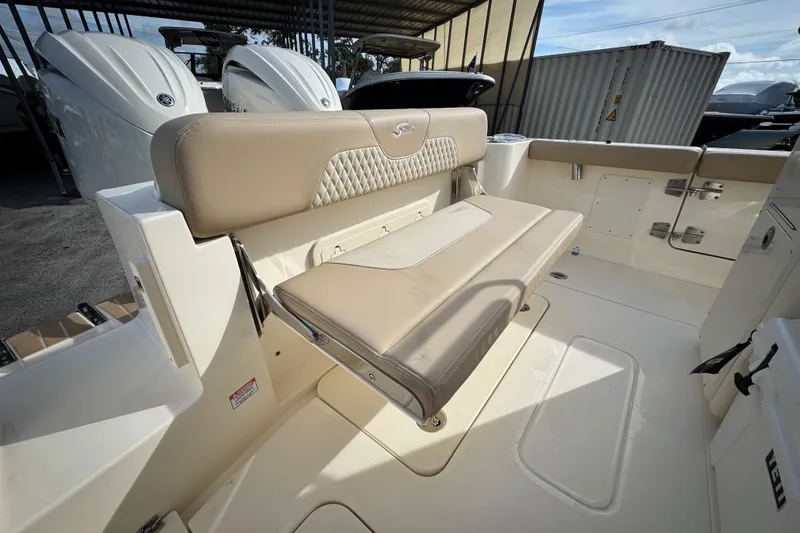 Slide: The Image of 2026 Scout 260 LXF boat interior with beige seating and storage compartments. - 12