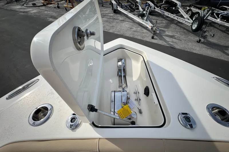 Slide: The Image of Open anchor compartment on 2026 Scout 260 LXF boat, showing winch and hardware. - 25