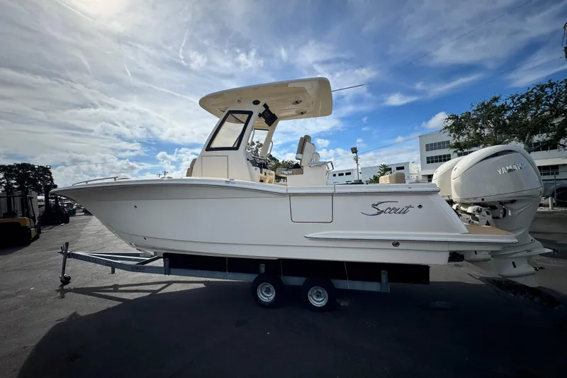 Slide: The Image of 2026 Scout 260 LXF boat on trailer under cloudy sky. - 3