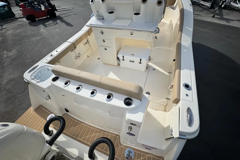 Slide: The Image of 2026 Scout 260 LXF boat interior with seating, storage, and fishing rod holders. - 6