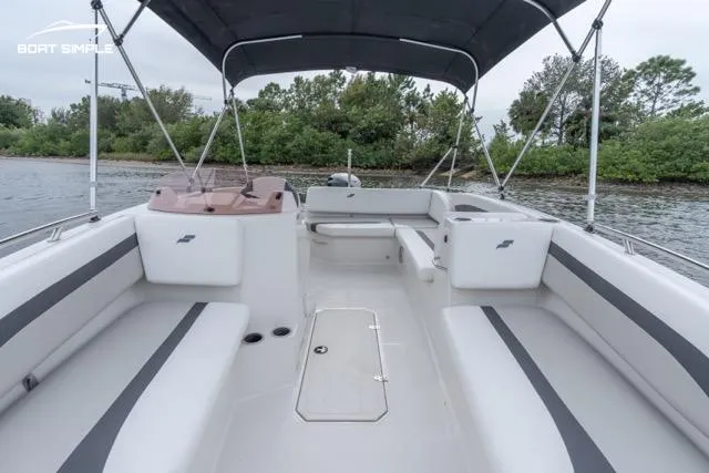 Slide: The Image of 2023 Starcraft SVX 171 OB boat interior with seating, canopy, and water view. - 4