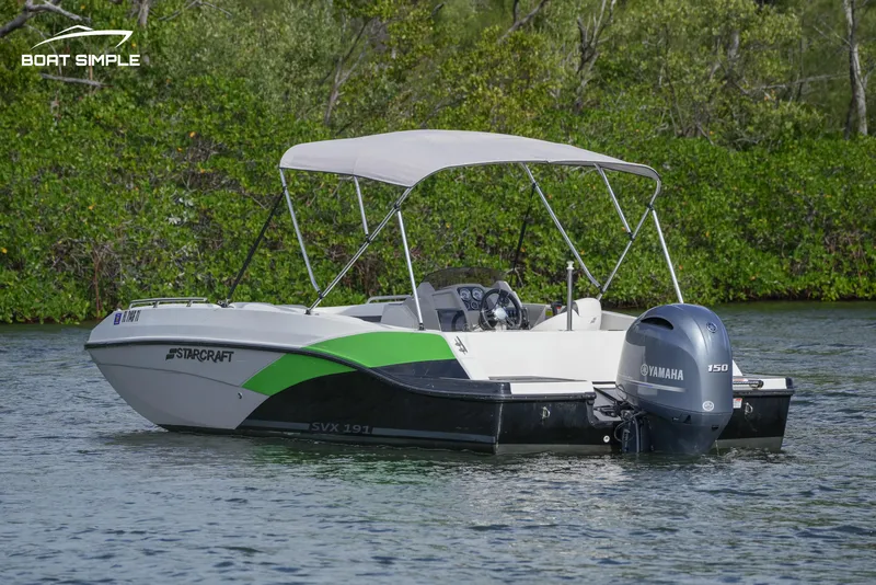 Slide: The Image of 2023 Starcraft SVX 191 OB boat with Yamaha engine on a calm lake. - 2
