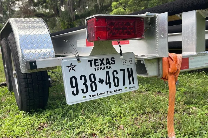 Slide: The Image of Texas trailer license plate on a Sportsman Open 252 Center Console, 2024 model. - 10