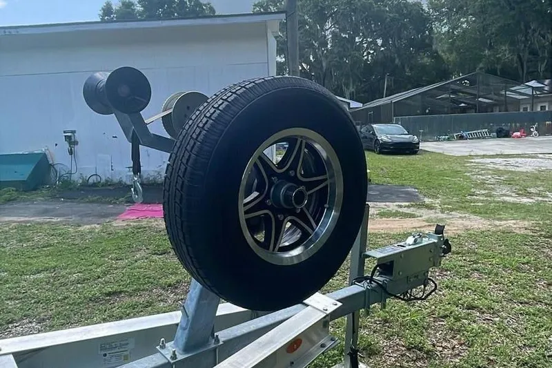 Slide: The Image of Trailer with spare tire for 2024 Sportsman Open 252 Center Console boat. - 11