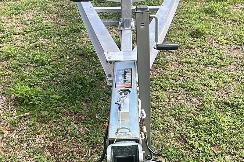 Slide: The Image of Trailer hitch of 2024 Sportsman Open 252 Center Console on grass. - 13