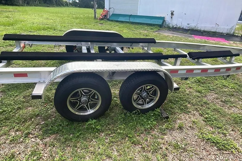 Slide: The Image of Trailer for 2024 Sportsman Open 252 Center Console on grass. - 15