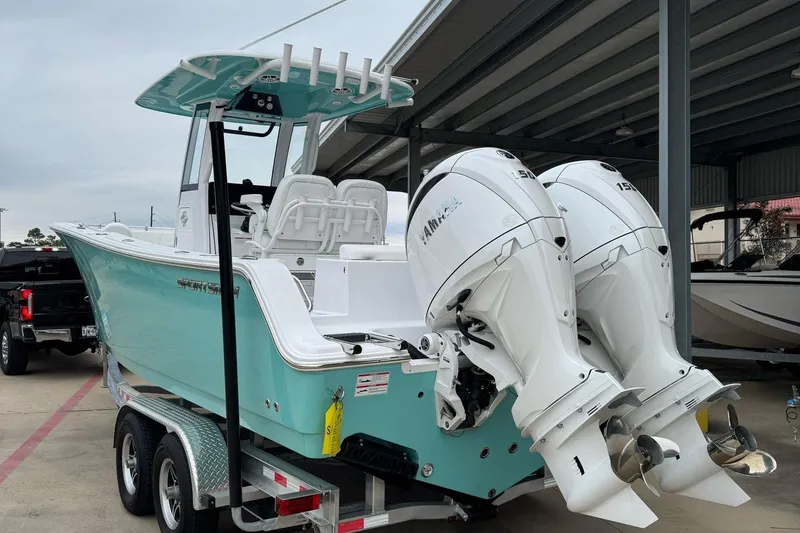 Slide: The Image of 2024 Sportsman Open 252 Center Console boat with dual Yamaha engines on a trailer. - 3