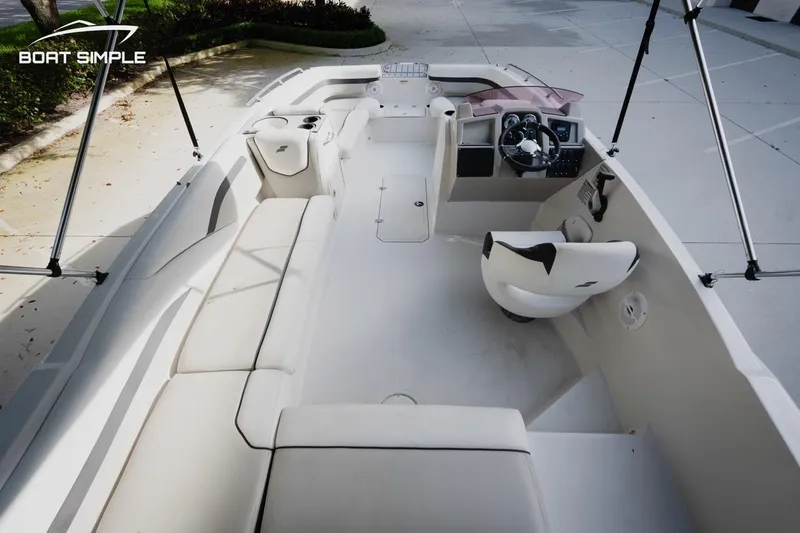 Slide: The Image of 2023 Starcraft SVX 211 OB boat interior with seating and steering console. - 12