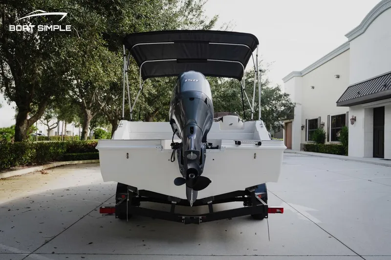 Slide: The Image of 2023 Starcraft SVX 211 OB boat with outboard motor on trailer, parked outdoors. - 5
